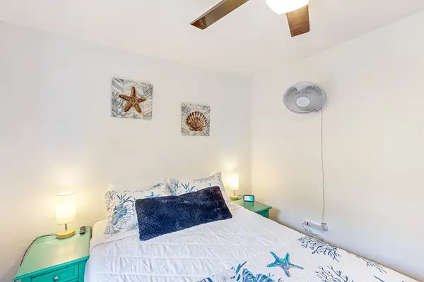 Guest room with queen bed, ceiling fan and an extra fan for your comfort.