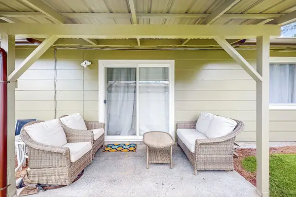Relax on the patio surrounded by lush greenery