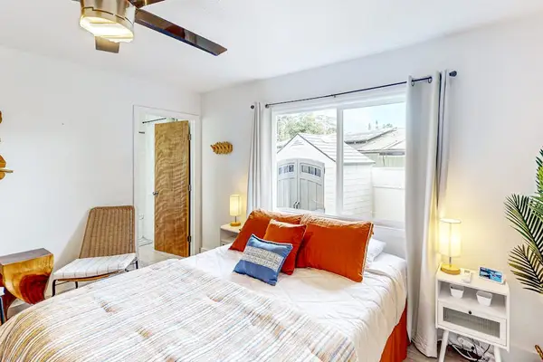 Master bedroom with queen bed with lots of windows for natural light and an en-suite bathroom