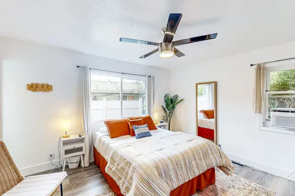 Master bedroom with queen bed and plenty of windows providing natural light.
