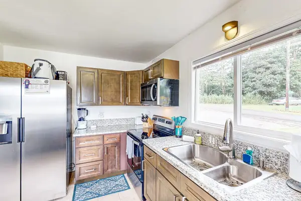 Fully equipped kitchen with stainless steel appliances.