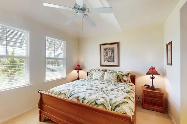 Bright Primary Suite with Wooden Bed Frame & Windows