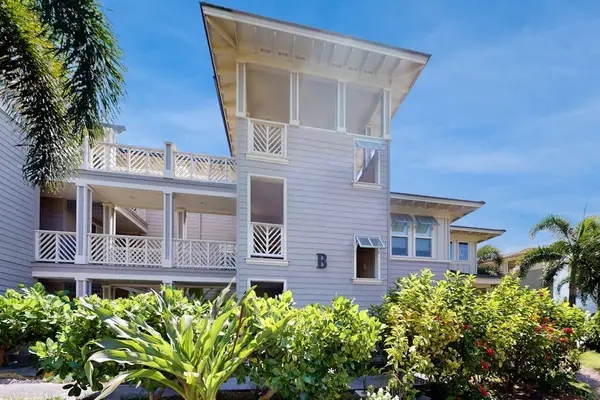 Property Exterior View with Covered Balconies & Palm Trees