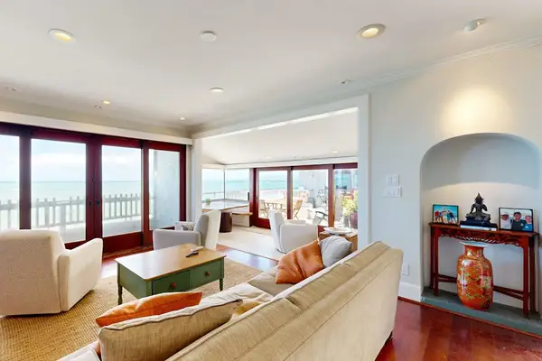 Unwind with panoramic water views from the sunlit living room every morning