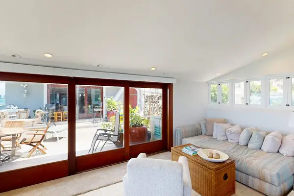 Bright living room showcases breathtaking water views through floor-to-ceiling glass every day