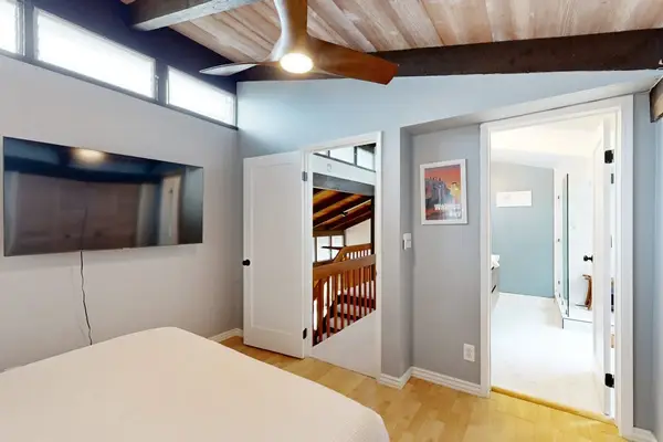 Recharge after a day out in a cool bedroom with convenient TV access.