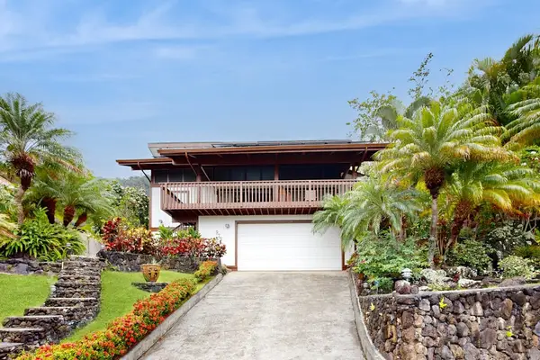 Discover a welcoming doorway nestled among lush island foliage.