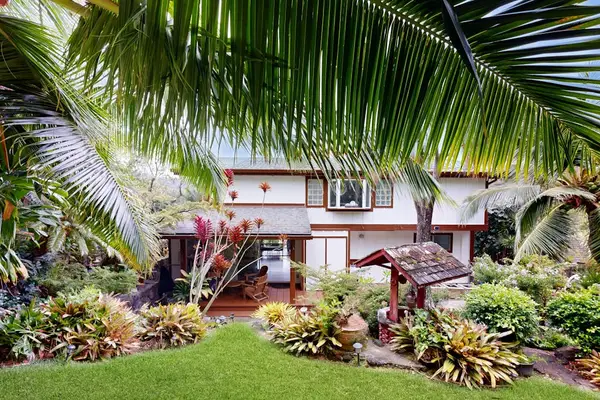 Arrive home to a welcoming entrance surrounded by lush tropical greenery.