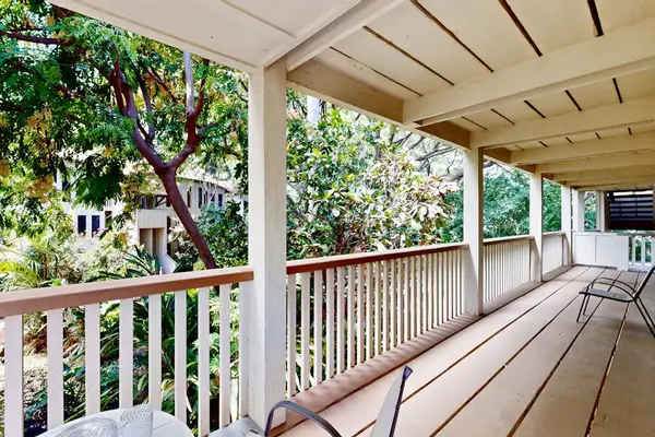Spacious lanai overlooking lush tropical greenery