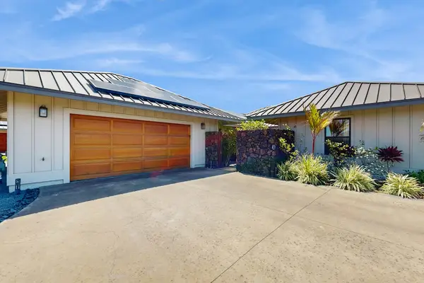 Modern Front Exterior with Wooden Garage Door, Solar Panels & Driveway