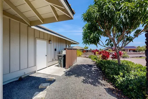 Side Exterior Pathway with Gravel Walk, Utility Area & Landscaping