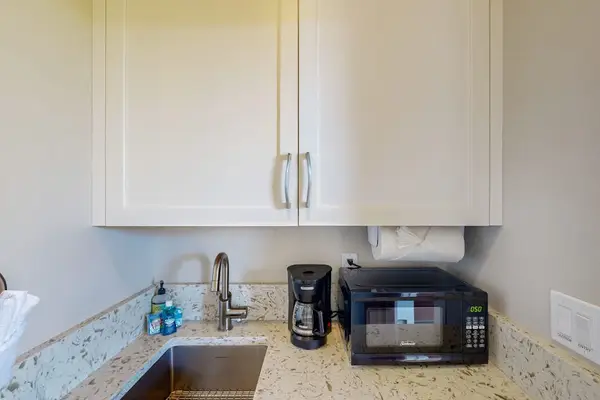Convenient Kitchenette Space with Wet Bar Sink, Microwave & Coffee Maker