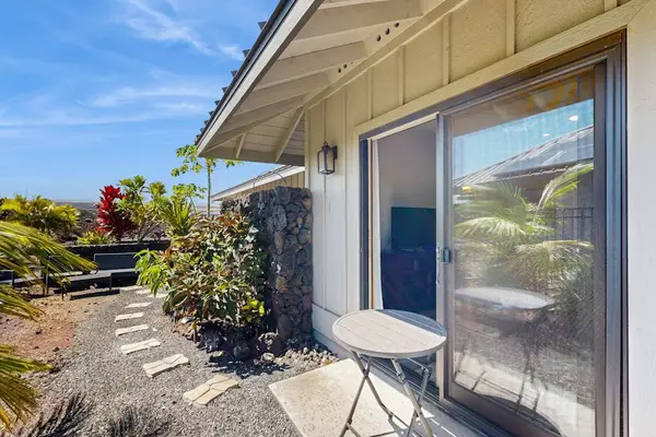Side Patio Area with Sliding Door Access & Tropical Plantings