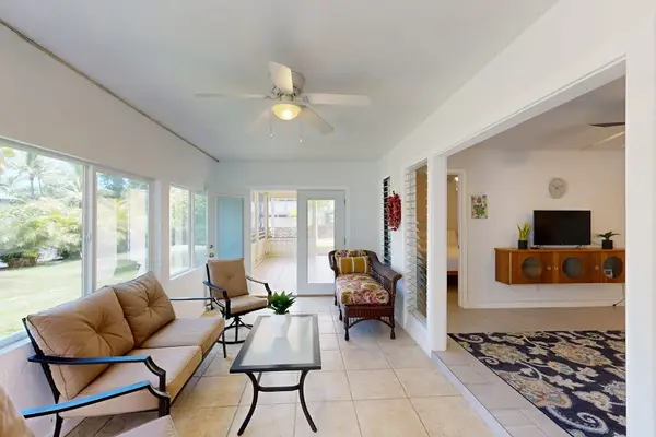 Open living room offers seating television ceiling fan and views