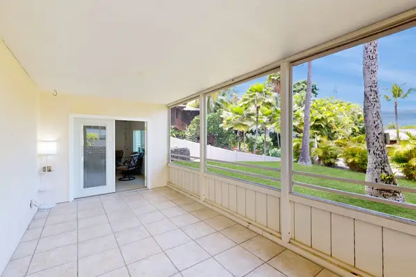 Covered patio invites mornings with garden views and tropical breezes
