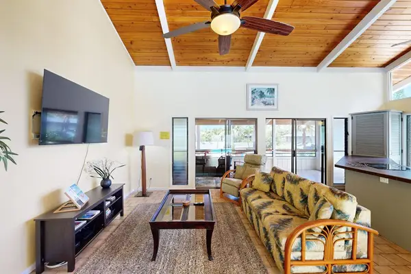 Bright Living Room with Flat-Screen TV & Vaulted Ceilings