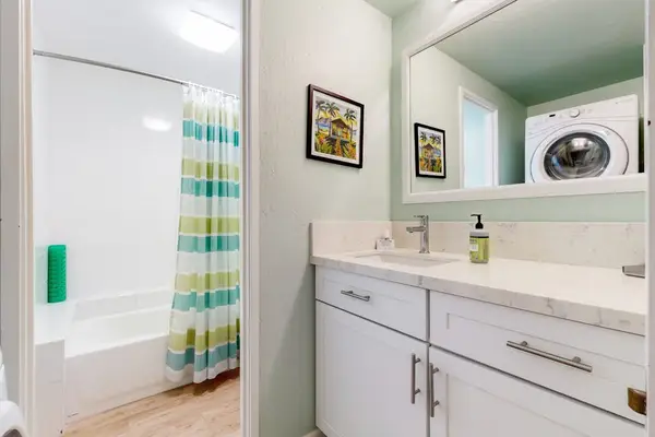 Full Bathroom With Tub And Laundry Convenience