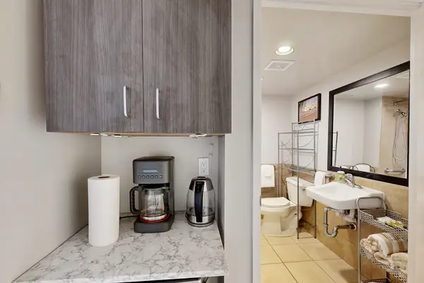 A convenient view of the bathroom area and cabinet space featuring a microwave for added comfort and functionality.