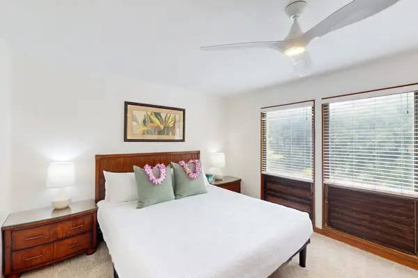 Spacious king bedroom with large windows and natural light