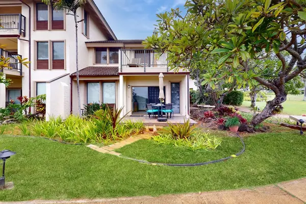 Charming tropical exterior surrounded by lush landscaping