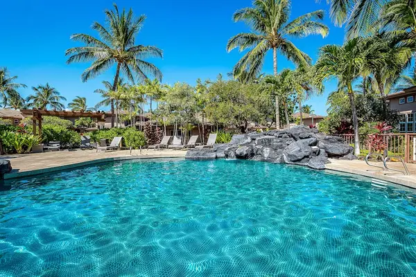 Tropical Oasis: Crystal-Clear Pool Framed By Rock Features