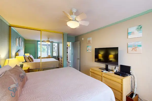 Bedroom With Smart TV And Balcony Access