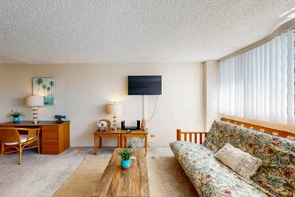 Bright open-concept studio features a comfortable living area perfect for relaxing after a day at Waikiki Beach.