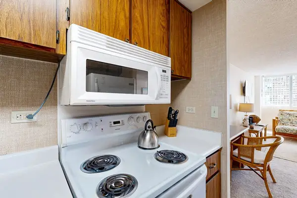 Prepare meals easily using the stove and over-the-range microwave provided in this efficient cooking area.