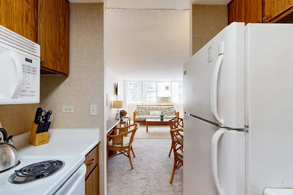 Enjoy a smooth transition from the kitchen to the welcoming studio layout, complete with a dedicated rattan dining set and seating area.