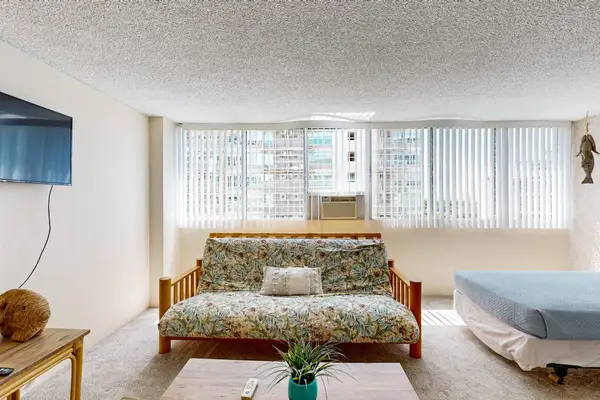Large windows fill the studio with natural light, creating a bright and welcoming atmosphere throughout the space.