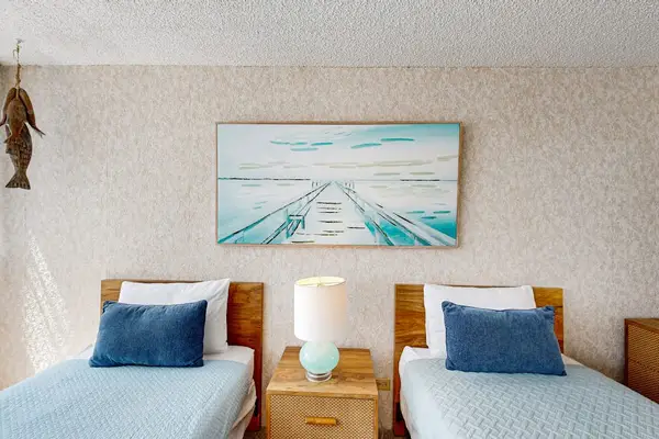 Two comfortable twin beds with plush linens provide a restful night's sleep after exploring Honolulu.