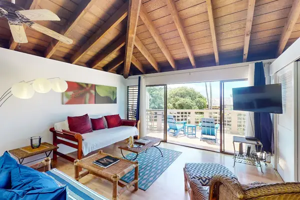 Open living room features comfortable seating and bright island views