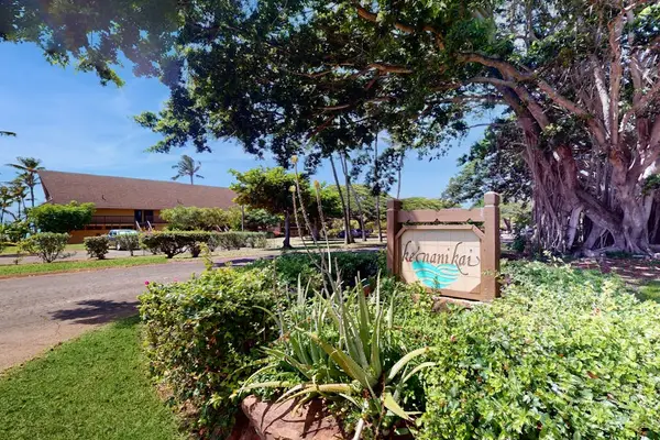 Tropical landscaping surrounds the property with welcoming greenery and shade
