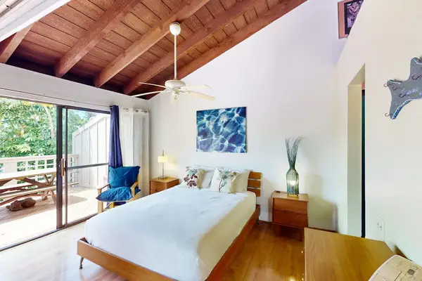 Bedroom opens toward bright views with queen bed comfort