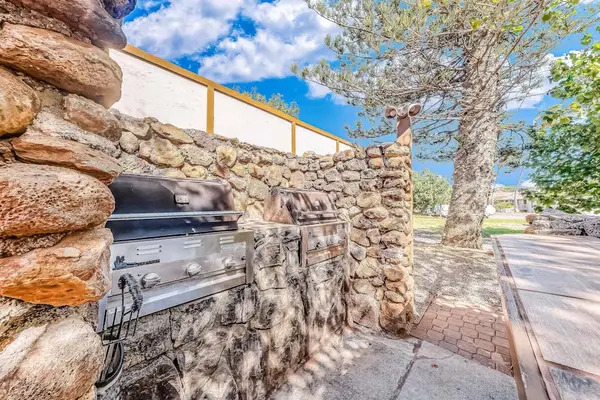 Welcoming stone pathway leads guests toward comfortable island living