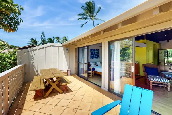 Balcony dining area offers outdoor seating beside inviting island home