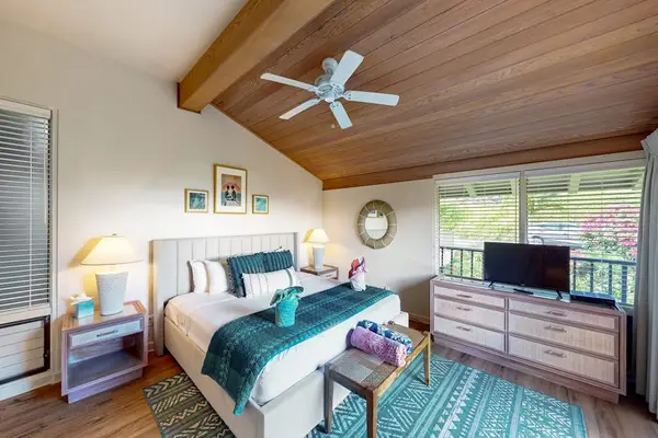 Peaceful Primary Bedroom With Vaulted Ceilings
