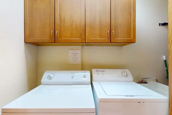 Washer and dryer area offers practical convenience during longer stays