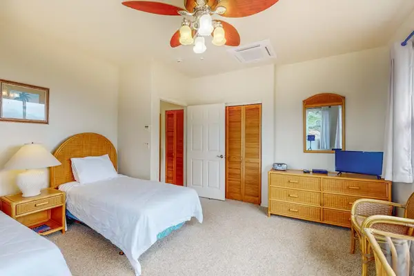 Second bedroom includes twin beds arranged for flexible group sleeping