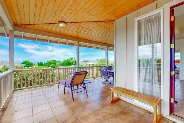 Wraparound balcony offers spacious outdoor seating overlooking beautiful island scenery