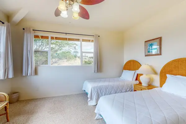 Second bedroom offers bright tropical styling and comfortable sleeping space