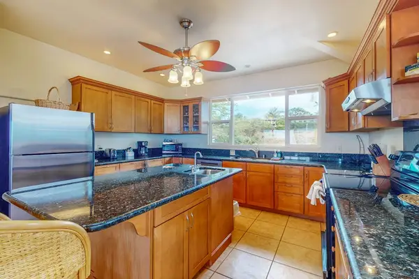Chef's kitchen showcases granite counters and practical cooking essentials