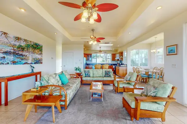 Bright living room welcomes guests with comfortable seating and sunlight