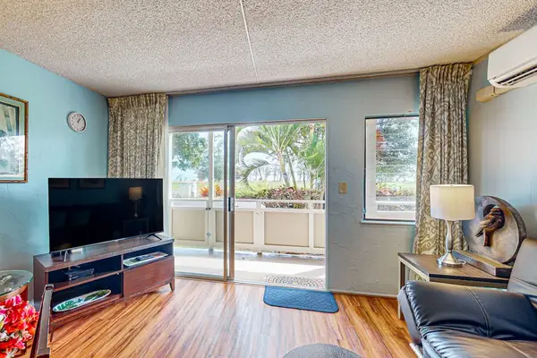 Lovely home decor, spacious living room with a flat screen tv and sleeper sofa.