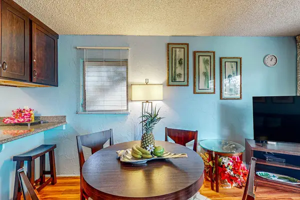 Dining room table with seating for four and barstools at kitchen counter for extra seating.