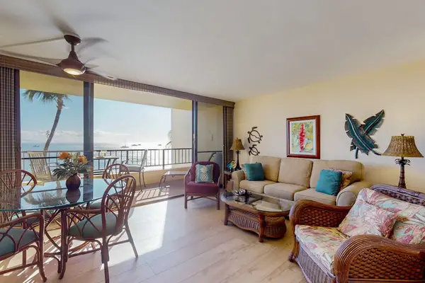 Bright living room with direct access to the private lanai, where beach views and swaying palm trees await.