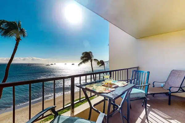 Private lanai with beautiful views of Maui's sandy beach, the sparkling Pacific Ocean, and swaying palm trees.