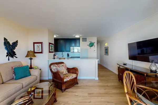 Bright living room with direct access to the private lanai, where beach views and swaying palm trees await.  With a flat screen TV for a little relaxation after a long day on Maui.