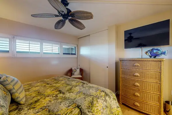 Bedroom with king bed, ceiling fan, en suite bathroom and a flat screen TV
