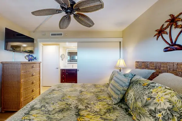 Bedroom with king bed, ceiling fan, en suite bathroom and a flat screen TV